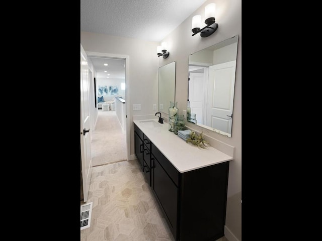 7881 Austin Way, Inver Grove Heights, MN 55077 - bathroom with vanity and a textured ceiling