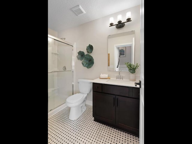 7881 Austin Way, Inver Grove Heights, MN 55077 - bathroom featuring a stall shower, vanity, and a textured ceiling