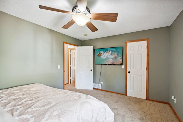 carpeted bedroom featuring baseboards and ceiling fan