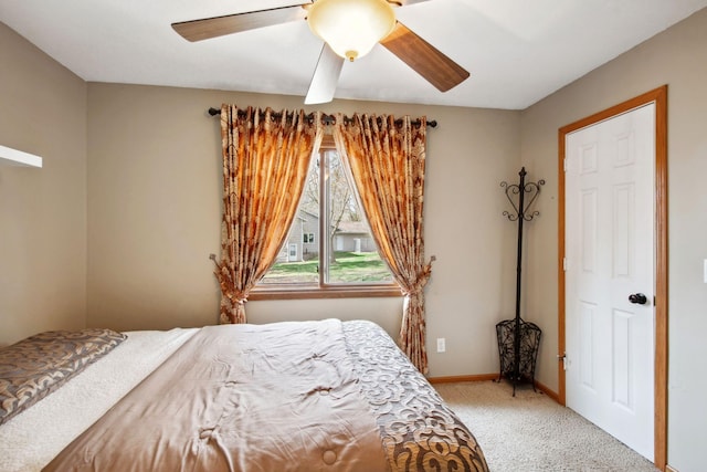 bedroom with baseboards, ceiling fan, and light carpet
