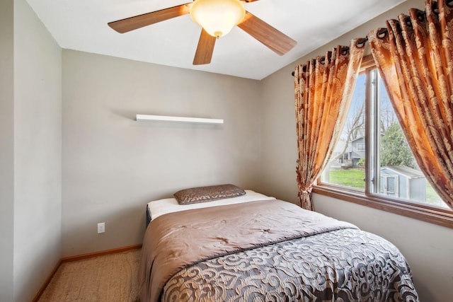 bedroom featuring a ceiling fan, baseboards, and carpet