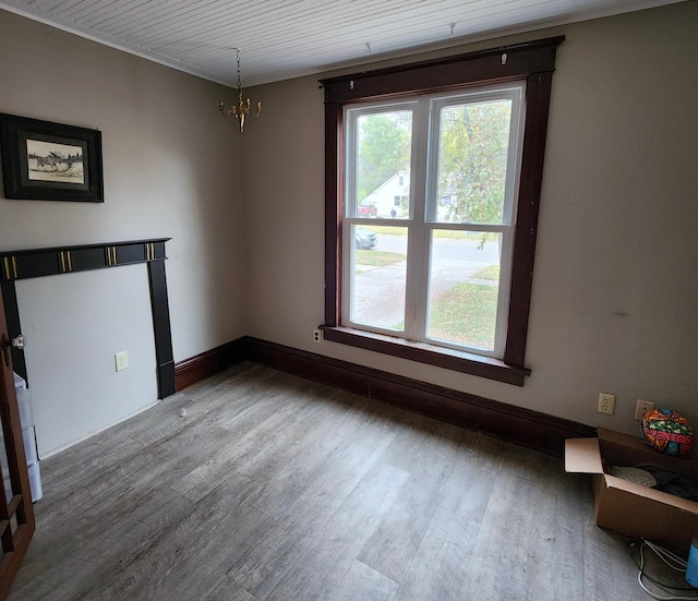 307 11th St NW, Willmar, MN 56201 - unfurnished dining area featuring plenty of natural light, baseboards, wood finished floors, and a notable chandelier