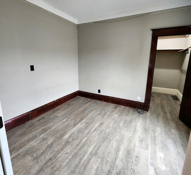 307 11th St NW, Willmar, MN 56201 - unfurnished room featuring baseboards and wood finished floors