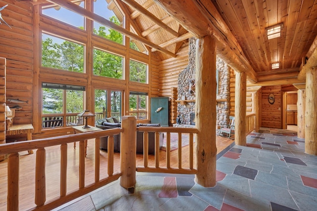 6070 Pilger Ave NW, Annandale, MN 55302 - hall with high vaulted ceiling, rustic walls, wood ceiling with exposed beams, and stone finish floors