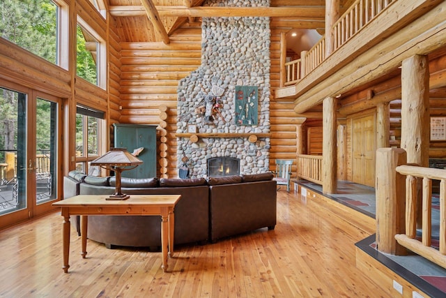 6070 Pilger Ave NW, Annandale, MN 55302 - living room with high vaulted ceiling, log walls, wood-type flooring, a fireplace, and wood ceiling with exposed beams