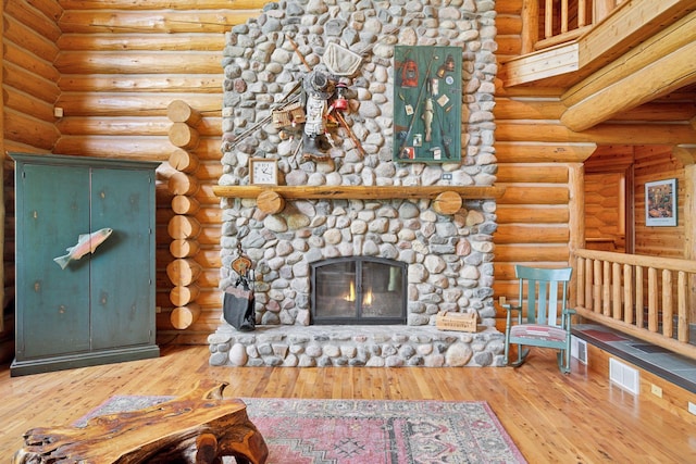 6070 Pilger Ave NW, Annandale, MN 55302 - unfurnished living room with a fireplace, wood-type flooring, and rustic walls