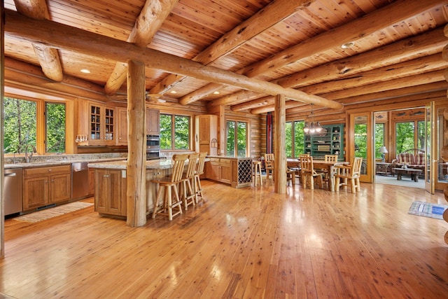 6070 Pilger Ave NW, Annandale, MN 55302 - dining area featuring wood ceiling with exposed beams, healthy amount of natural light, light wood-type flooring, a chandelier, and rustic walls