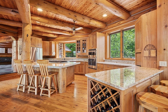 6070 Pilger Ave NW, Annandale, MN 55302 - kitchen featuring appliances with stainless steel finishes, a kitchen bar, plenty of natural light, wood ceiling with exposed beams, and rustic walls