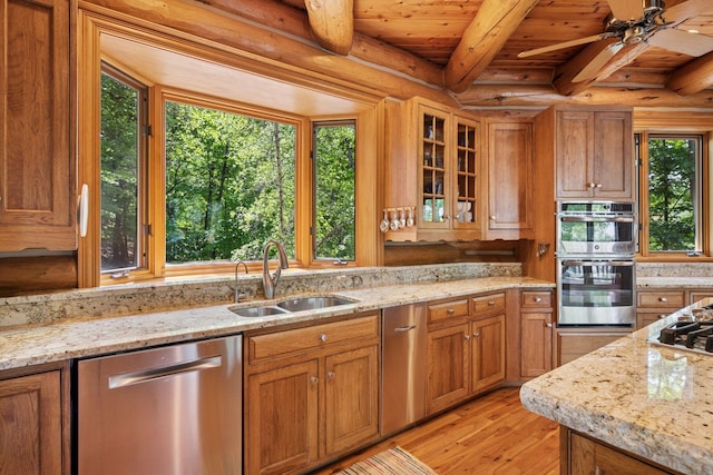 6070 Pilger Ave NW, Annandale, MN 55302 - kitchen with stainless steel appliances, a sink, light wood-type flooring, brown cabinets, and a ceiling fan