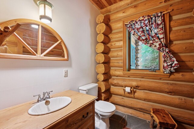 6070 Pilger Ave NW, Annandale, MN 55302 - half bathroom featuring log walls, vanity, and toilet
