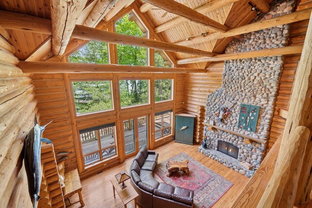 6070 Pilger Ave NW, Annandale, MN 55302 - living area with rustic walls, healthy amount of natural light, high vaulted ceiling, hardwood / wood-style floors, and wooden ceiling with exposed beams