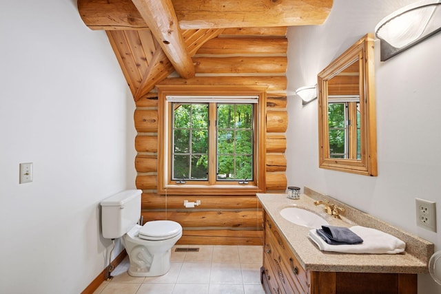 6070 Pilger Ave NW, Annandale, MN 55302 - bathroom featuring rustic walls, toilet, beamed ceiling, vanity, and tile patterned flooring