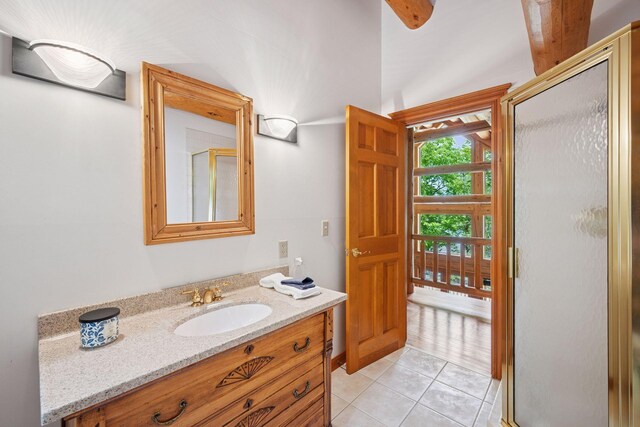 6070 Pilger Ave NW, Annandale, MN 55302 - full bathroom featuring vanity, a shower stall, tile patterned flooring, and vaulted ceiling