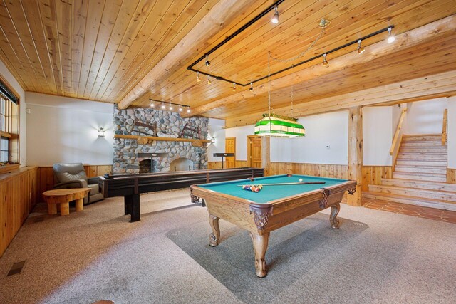 6070 Pilger Ave NW, Annandale, MN 55302 - recreation room featuring track lighting, wooden walls, carpet flooring, wainscoting, and a stone fireplace