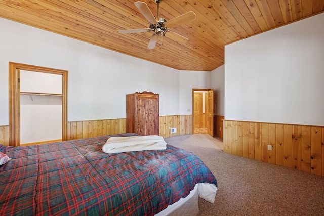 6070 Pilger Ave NW, Annandale, MN 55302 - carpeted bedroom with wainscoting, wooden ceiling, wooden walls, and ceiling fan