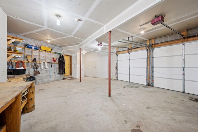 6070 Pilger Ave NW, Annandale, MN 55302 - garage with a garage door opener, concrete block wall, and a workshop area