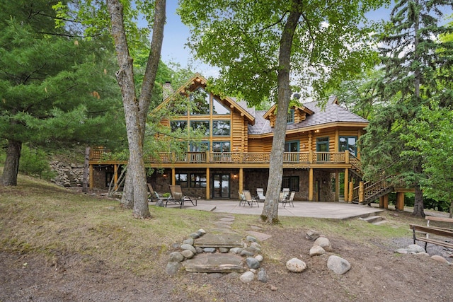 6070 Pilger Ave NW, Annandale, MN 55302 - rear view of property with log exterior, a patio area, a deck, stairway, and stone siding
