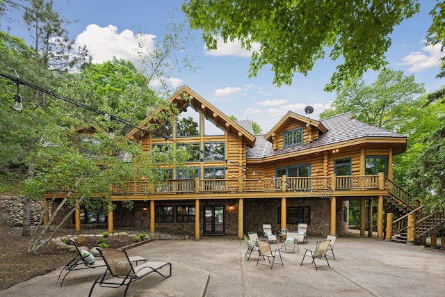 6070 Pilger Ave NW, Annandale, MN 55302 - rear view of property featuring log siding, a patio area, stairs, a deck, and stone siding