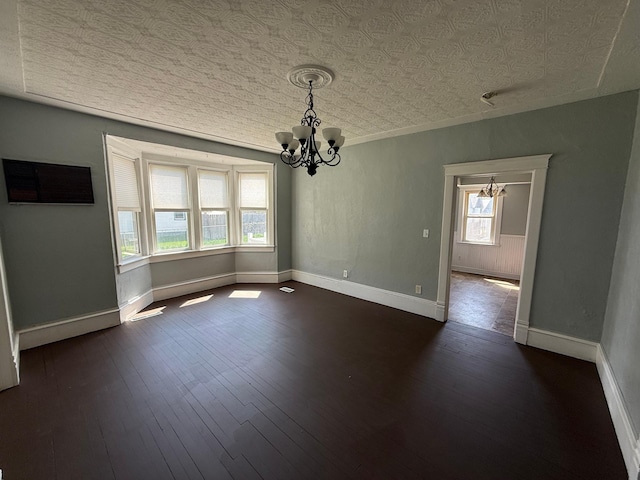 300 4th St SW, Little Falls, MN 56345 - unfurnished dining area with a chandelier, baseboards, and dark wood finished floors