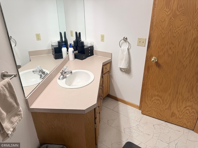 bathroom with vanity and marble finish floor