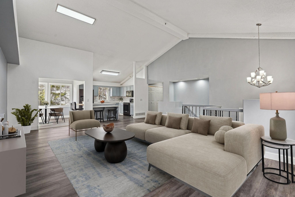 living area with beamed ceiling, dark wood-style floors, high vaulted ceiling, and a notable chandelier