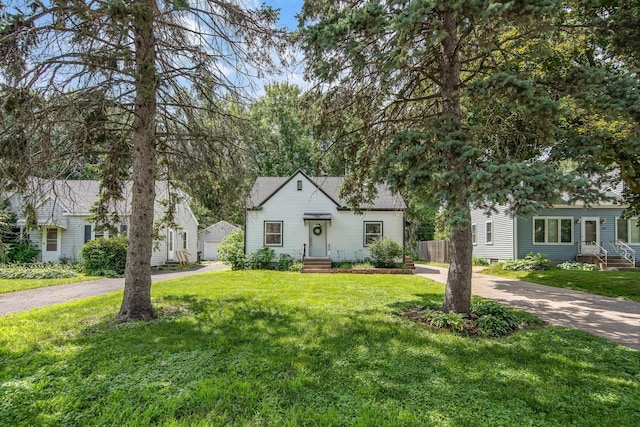 1759 Flandrau St, Maplewood, MN 55109 - view of front of house with a front lawn and driveway