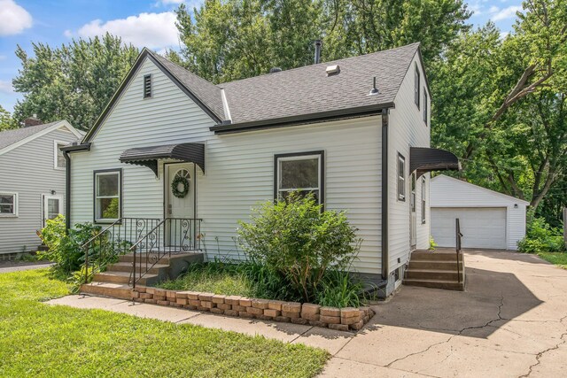 1759 Flandrau St, Maplewood, MN 55109 - view of front of home with an outbuilding, a shingled roof, and a garage