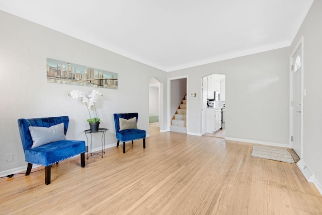 1759 Flandrau St, Maplewood, MN 55109 - living area featuring arched walkways, wood finished floors, and stairway