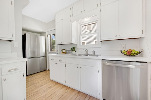 1759 Flandrau St, Maplewood, MN 55109 - kitchen with appliances with stainless steel finishes, light wood-style floors, white cabinetry, and light countertops