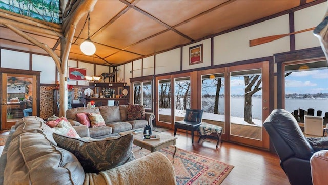 1007 Van Dyke Rd NW, Alexandria, MN 56308 - living area with a water view, wood finished floors, a chandelier, and french doors