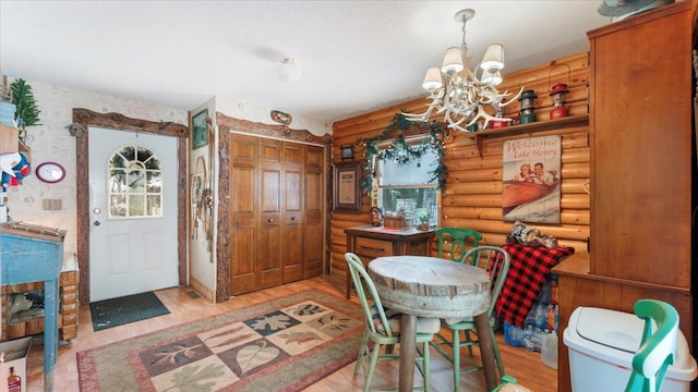 1007 Van Dyke Rd NW, Alexandria, MN 56308 - dining area with a chandelier, rustic walls, and light wood-style flooring