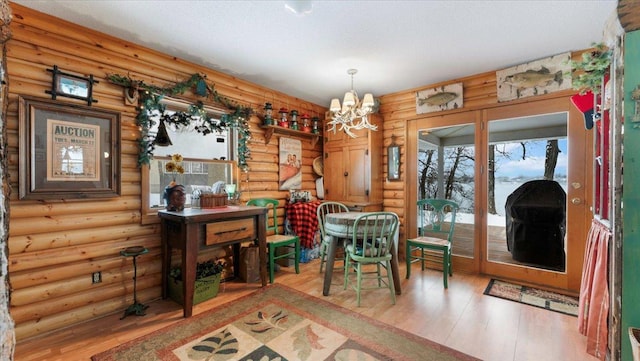 1007 Van Dyke Rd NW, Alexandria, MN 56308 - dining area with hardwood / wood-style floors, a chandelier, and log walls