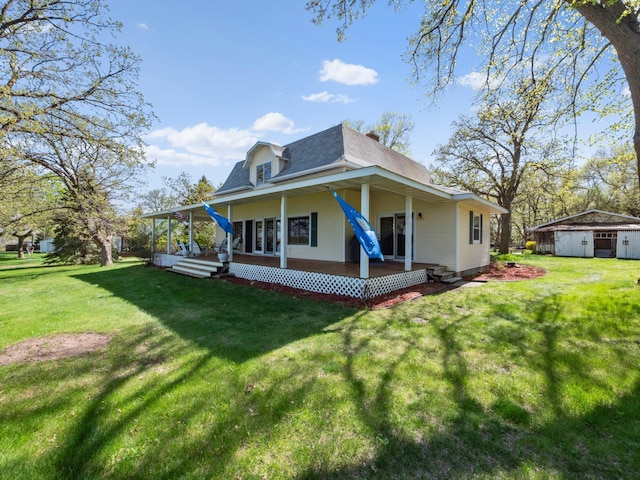 1007 Van Dyke Rd NW, Alexandria, MN 56308 - rear view of house featuring covered porch, a yard, roof with shingles, and an outbuilding