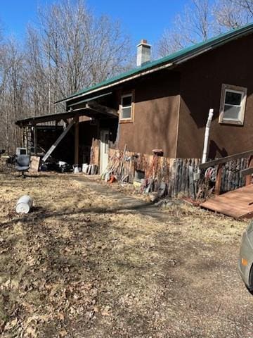 3338 130th St, Frederic, WI 54837 - view of property exterior featuring a chimney and a deck