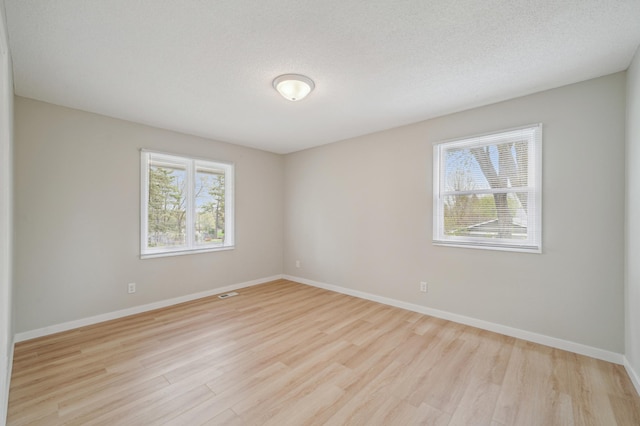unfurnished room featuring wood finished floors and baseboards