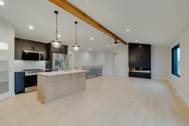 1824 Brandt Dr NE, Byron, MN 55920 - kitchen with appliances with stainless steel finishes, light countertops, light wood-style flooring, and a kitchen island with sink