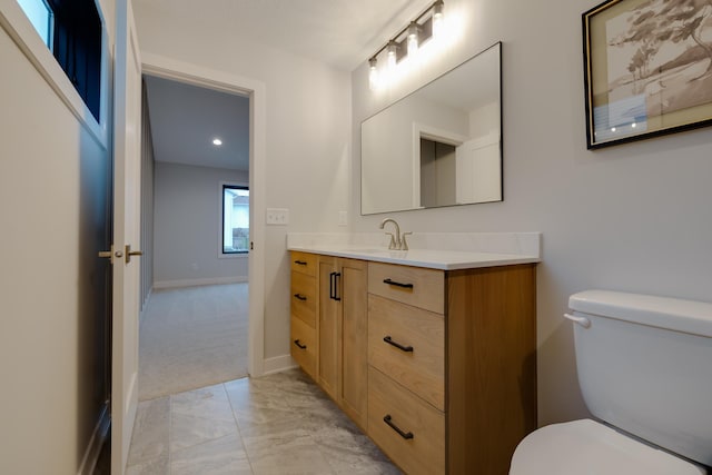 1824 Brandt Dr NE, Byron, MN 55920 - bathroom with marble finish floors, toilet, vanity, baseboards, and recessed lighting