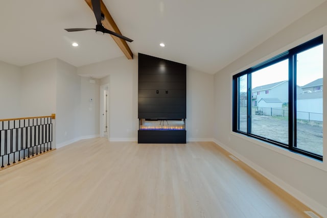 1824 Brandt Dr NE, Byron, MN 55920 - unfurnished living room featuring light wood-type flooring, a glass covered fireplace, a ceiling fan, baseboards, and recessed lighting