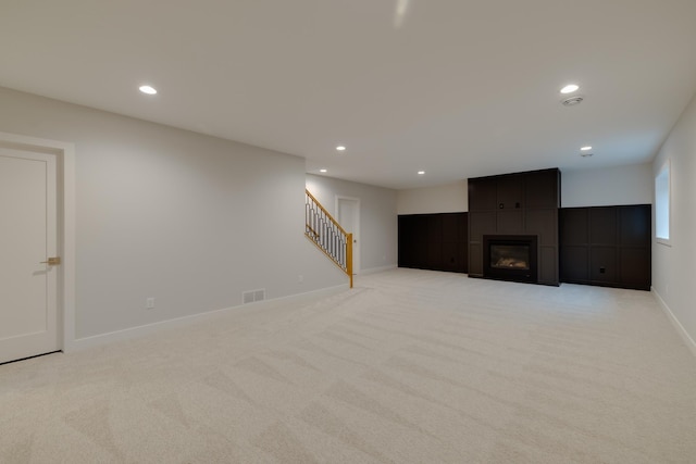 1824 Brandt Dr NE, Byron, MN 55920 - below grade area featuring recessed lighting, light carpet, stairs, baseboards, and a fireplace