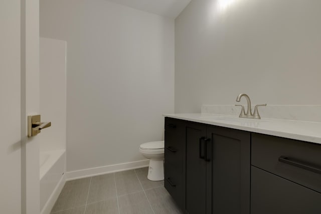 1824 Brandt Dr NE, Byron, MN 55920 - full bath featuring vanity, toilet, baseboards, a tub to relax in, and tile patterned flooring
