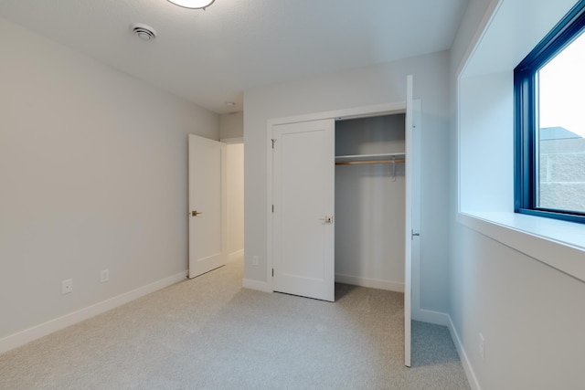 1824 Brandt Dr NE, Byron, MN 55920 - unfurnished bedroom featuring a closet, light colored carpet, and baseboards