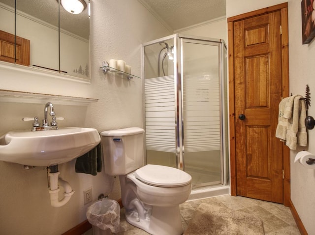full bathroom featuring ornamental molding, a shower stall, and a textured ceiling