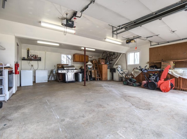 garage featuring a garage door opener and refrigerator