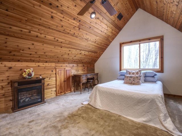 carpeted bedroom featuring a glass covered fireplace, wooden ceiling, a ceiling fan, and vaulted ceiling