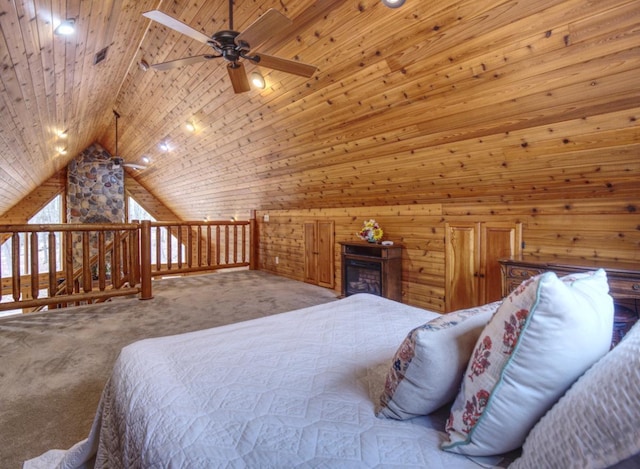 carpeted bedroom with wooden walls, visible vents, and lofted ceiling