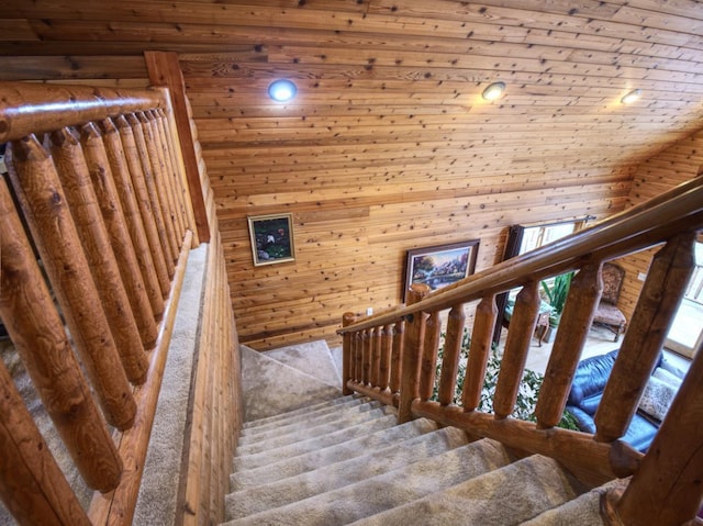 staircase featuring recessed lighting, wooden walls, and wooden ceiling