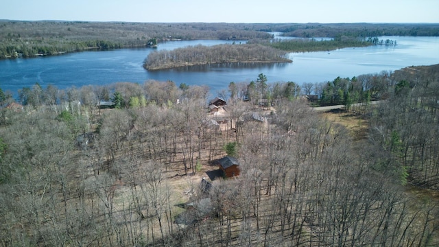 aerial view with a wooded view and a water view