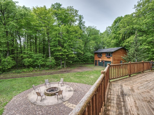 14534 290th Ave, Sampson Twp, WI 54757 - view of green lawn with a fire pit, an outdoor structure, a deck, a garage, and a patio