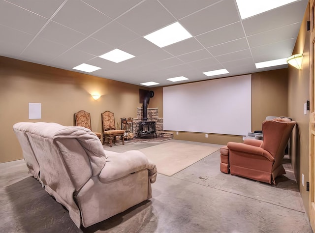 14534 290th Ave, Sampson Twp, WI 54757 - living area with a wood stove, a paneled ceiling, and concrete flooring