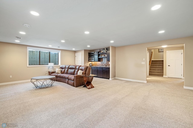 2704 1st St E, West Fargo, ND 58078 - living area with bar area, stairway, light carpet, baseboards, and recessed lighting